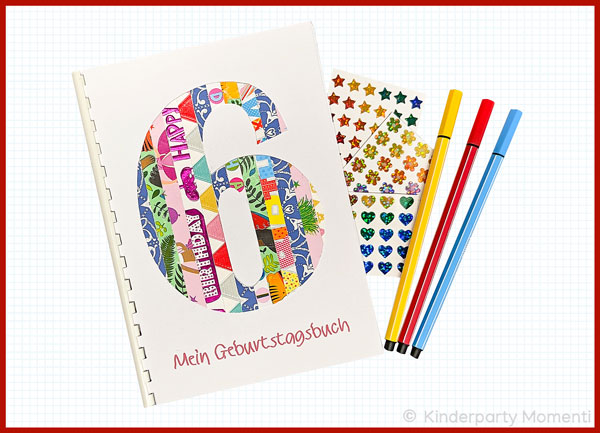 ein A5 Geburtstagsbuch mit einer sechs aus Geschenk-Papierstreifen, daneben kleine Sticker und drei Fineliner