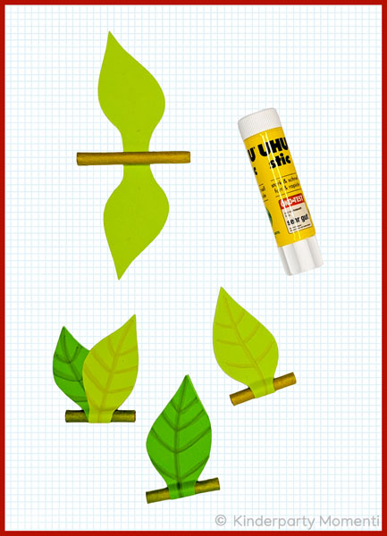 kleine Blätter an Papierstrohhalme geklebt, Klebestift